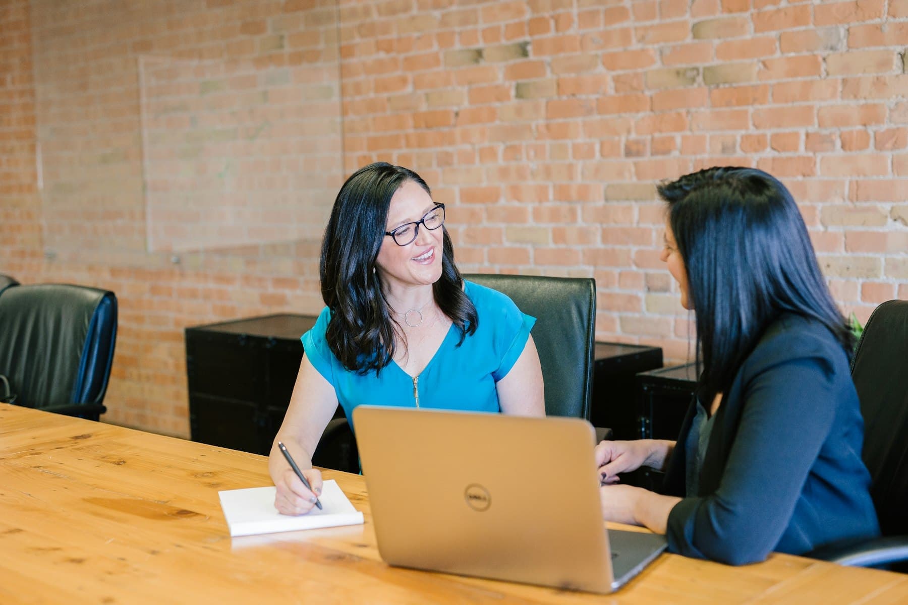 An adviser talking a student through options at a desk